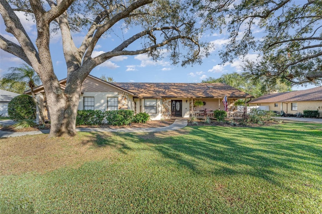 ranch-style home with a front lawn