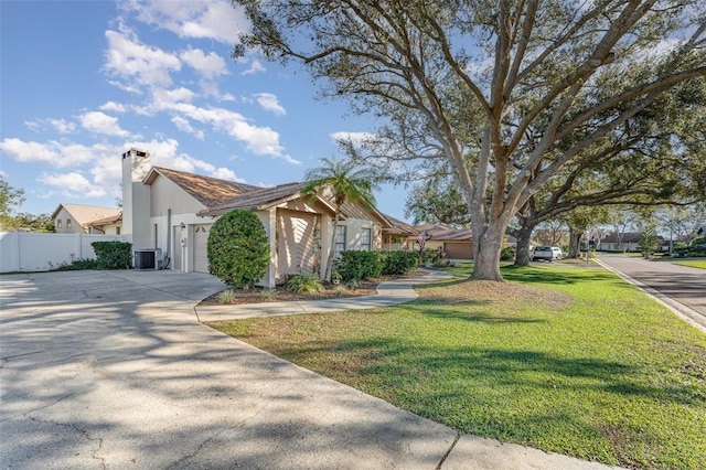 view of front of home with a garage, central air condition unit, and a front lawn