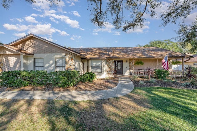 single story home featuring a front lawn and a porch