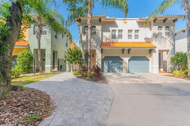 mediterranean / spanish home with a garage