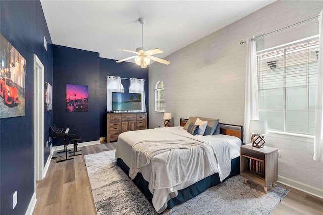 bedroom with wood-type flooring and ceiling fan