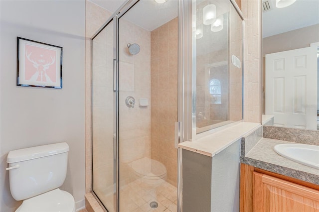 bathroom with vanity, toilet, and a shower with door