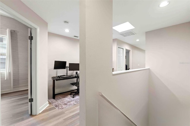 hallway with light hardwood / wood-style flooring