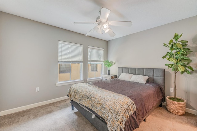 bedroom featuring ceiling fan and light carpet