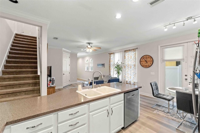 kitchen with ceiling fan, dishwasher, sink, white cabinets, and ornamental molding