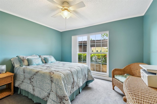 carpeted bedroom with a textured ceiling, ceiling fan, and ornamental molding