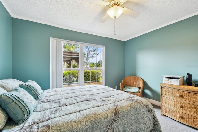 bedroom featuring ceiling fan, crown molding, carpet floors, and a textured ceiling