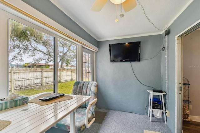 sunroom / solarium featuring ceiling fan