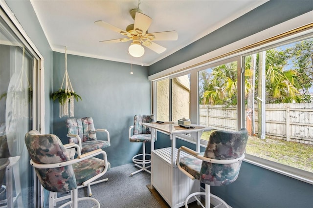 sunroom featuring ceiling fan