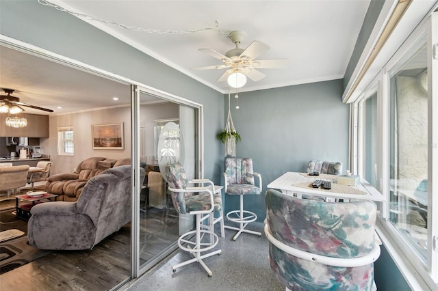 living room featuring ceiling fan and crown molding