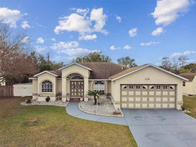 ranch-style home with french doors, a front lawn, and a garage