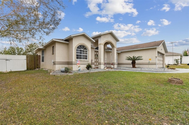 view of front of home with a front lawn and a garage