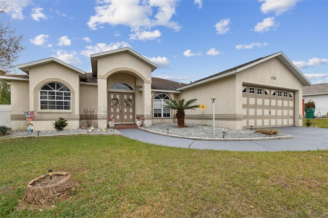 view of front of home featuring a front lawn and a garage