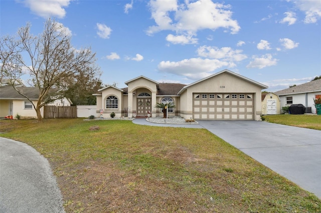 ranch-style home featuring a front lawn and a garage