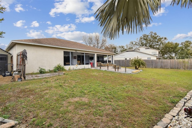 back of property featuring a yard and a patio