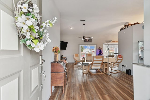 foyer entrance featuring hardwood / wood-style floors, ceiling fan, and a high ceiling