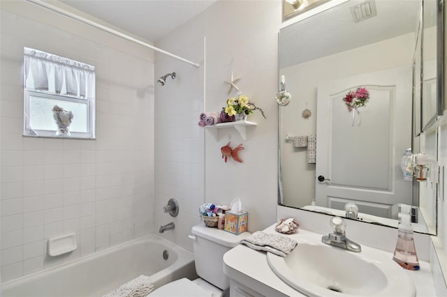 full bathroom featuring vanity, toilet, and tiled shower / bath