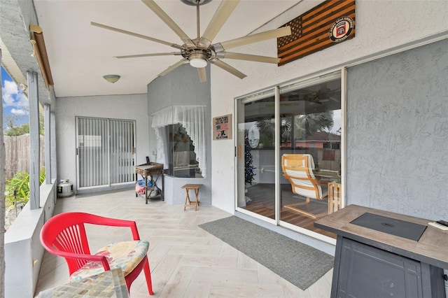 sunroom with ceiling fan and vaulted ceiling