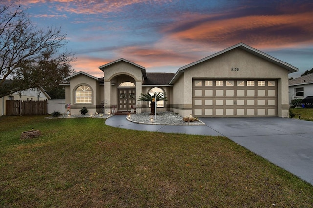 view of front facade featuring a yard and a garage