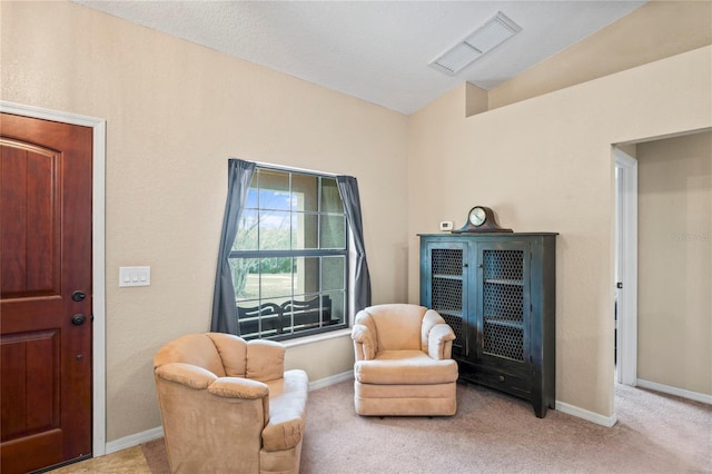 living area featuring light carpet