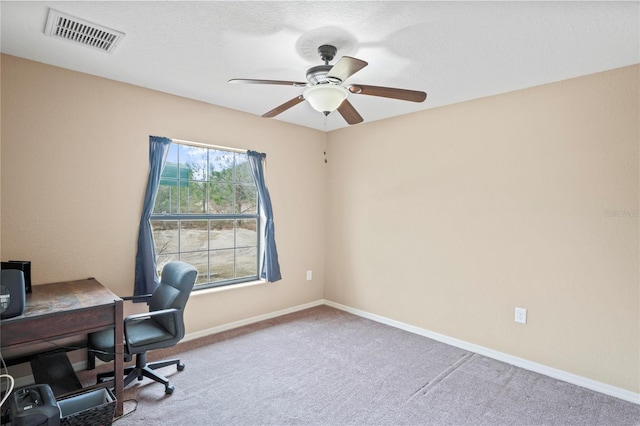 home office with light carpet and ceiling fan