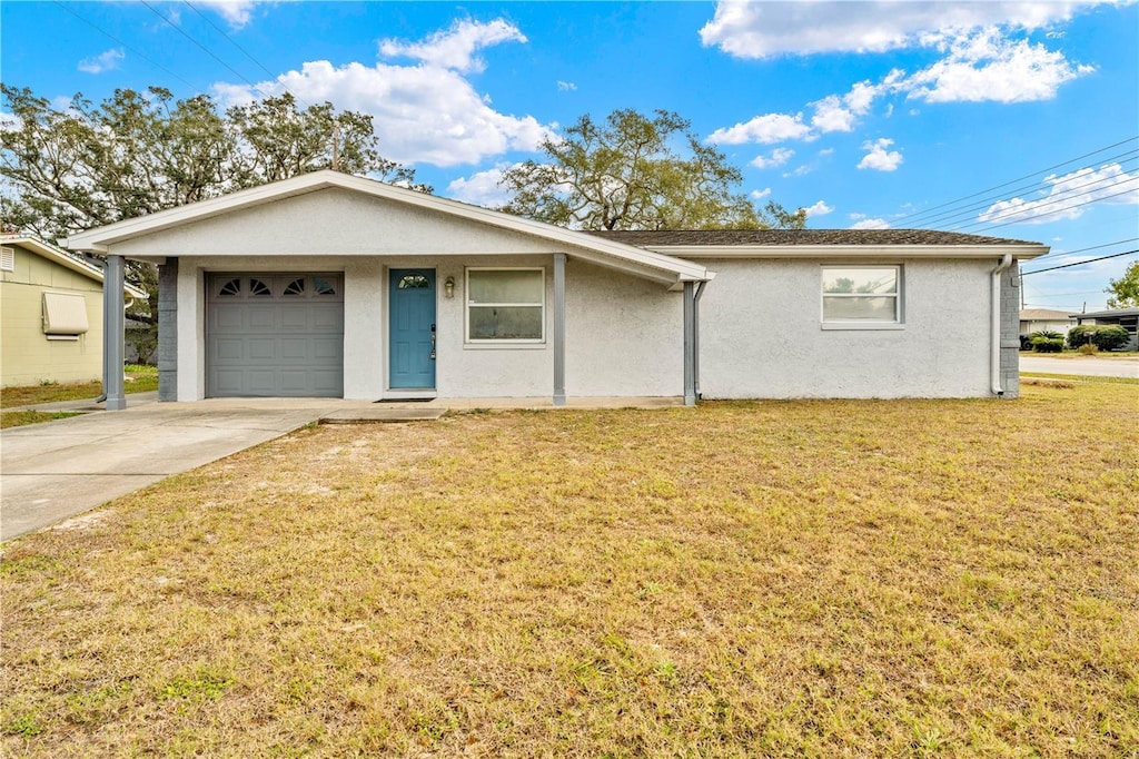 single story home featuring a garage and a front lawn