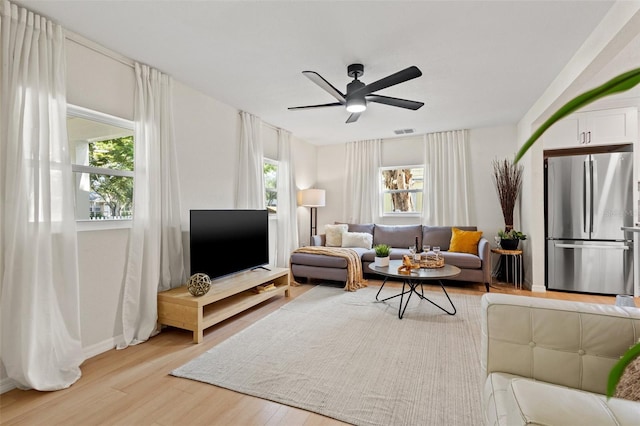 living room featuring ceiling fan and light hardwood / wood-style floors