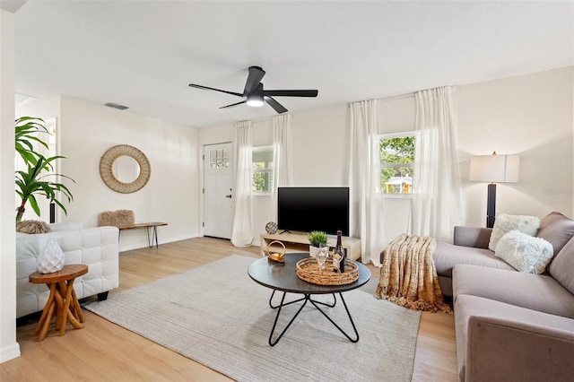 living room with light wood-type flooring and ceiling fan