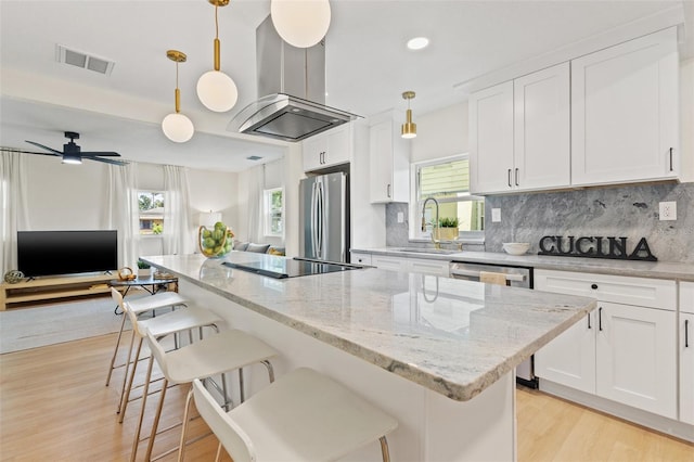 kitchen featuring sink, white cabinets, pendant lighting, and appliances with stainless steel finishes