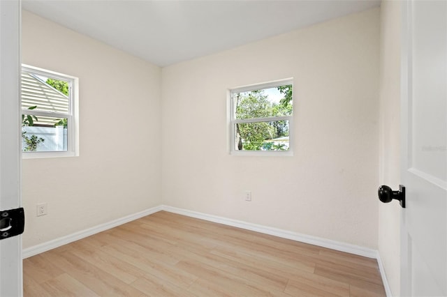 spare room with plenty of natural light and light wood-type flooring