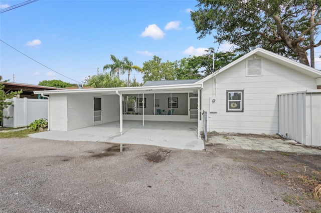 rear view of property with a carport