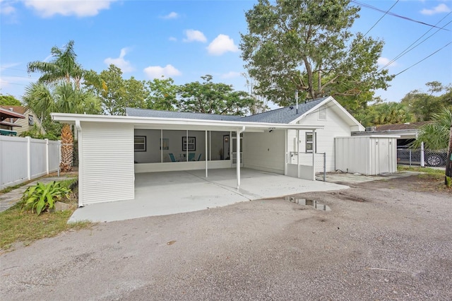 back of property with a carport