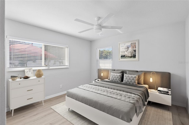 bedroom with ceiling fan and light hardwood / wood-style flooring