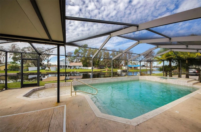 view of swimming pool featuring glass enclosure, a patio area, and a water view