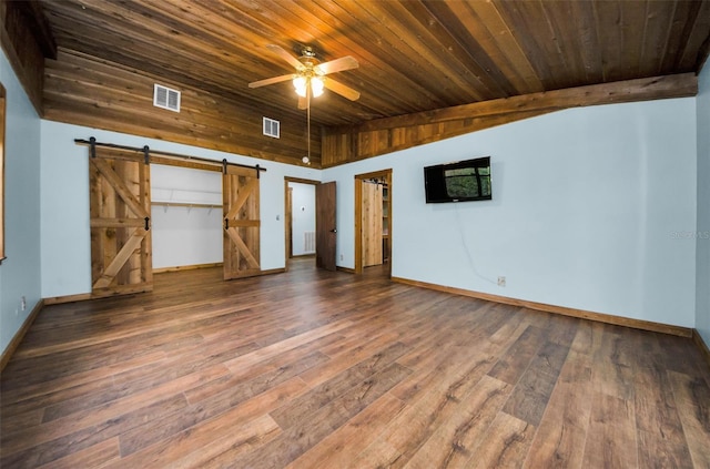 unfurnished bedroom with dark hardwood / wood-style floors, a barn door, wooden ceiling, and lofted ceiling