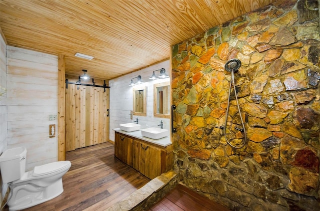 bathroom featuring hardwood / wood-style floors, vanity, wooden ceiling, wooden walls, and toilet