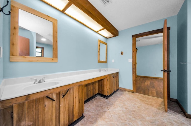 bathroom featuring tile patterned flooring and vanity