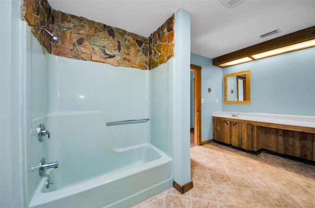 bathroom with bathtub / shower combination, vanity, and tile patterned flooring