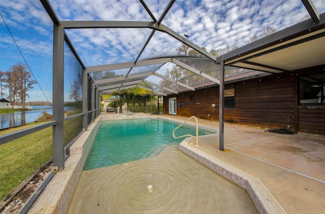 view of swimming pool featuring a patio, a water view, and a lanai