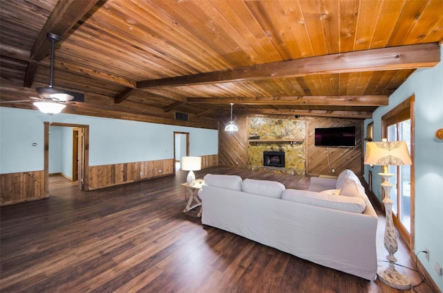 living room with wooden ceiling, lofted ceiling with beams, wooden walls, dark hardwood / wood-style floors, and a fireplace