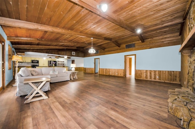 unfurnished living room featuring hardwood / wood-style floors, beam ceiling, and wooden ceiling