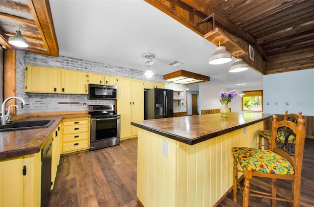 kitchen featuring wooden counters, sink, dark hardwood / wood-style floors, and black appliances