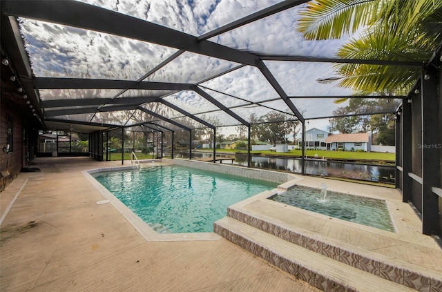 view of swimming pool featuring glass enclosure, pool water feature, a patio area, and a water view