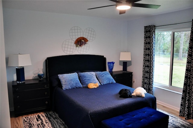 bedroom with hardwood / wood-style floors and ceiling fan