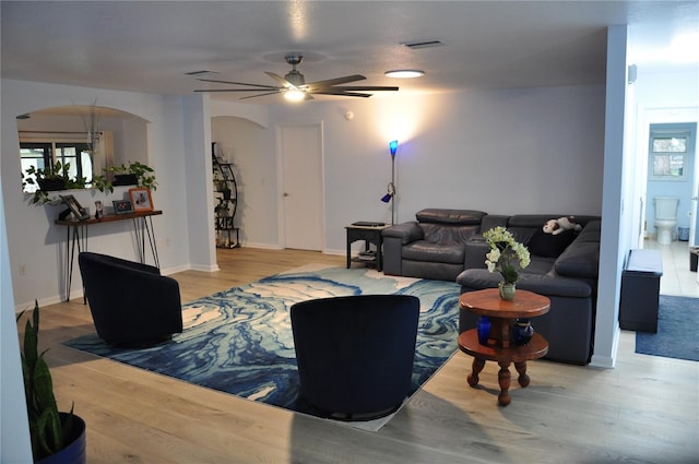 living room featuring ceiling fan and light hardwood / wood-style flooring