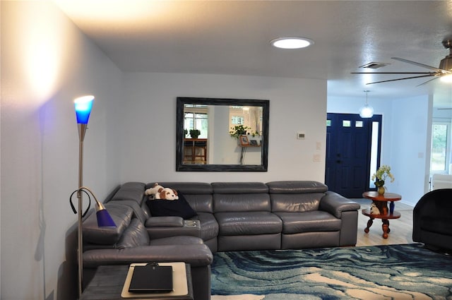 living room featuring ceiling fan and wood-type flooring