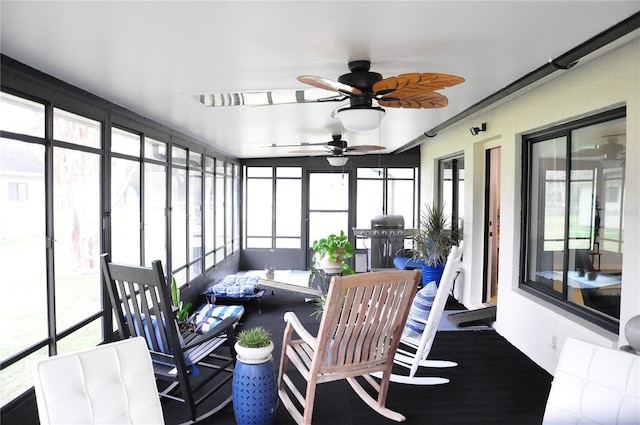 sunroom / solarium with a wealth of natural light and ceiling fan