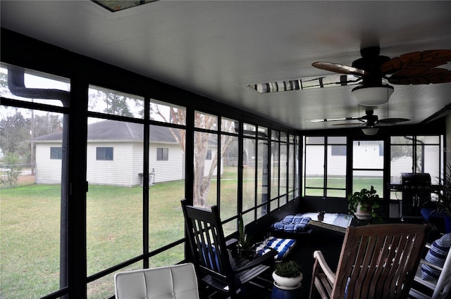 sunroom / solarium featuring ceiling fan