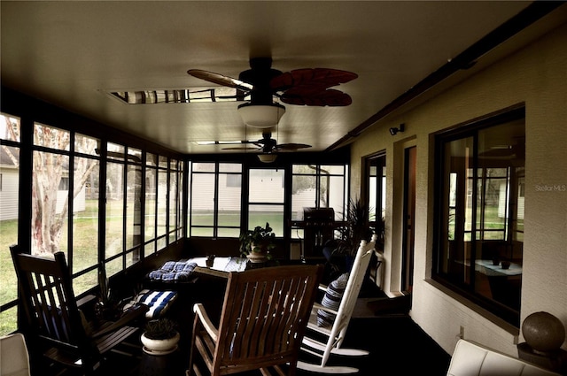 sunroom / solarium featuring ceiling fan