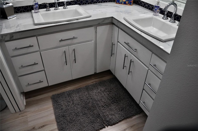 bathroom with hardwood / wood-style floors and vanity